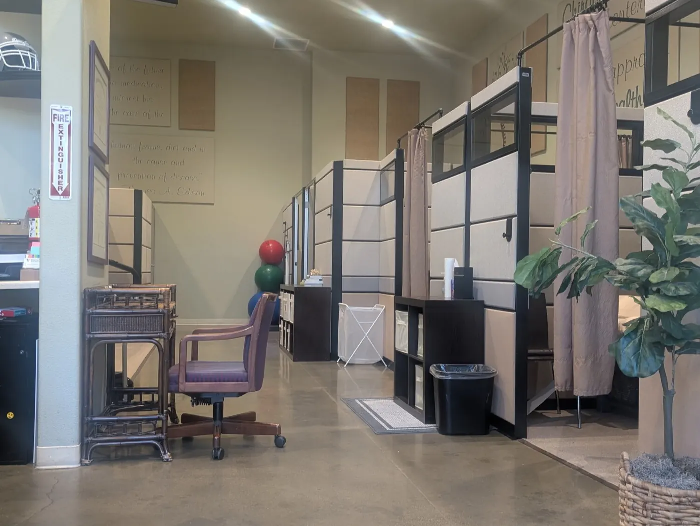Open treatment floor at the Mountain House office with partitioned adjusting bays and exercise balls along the wall