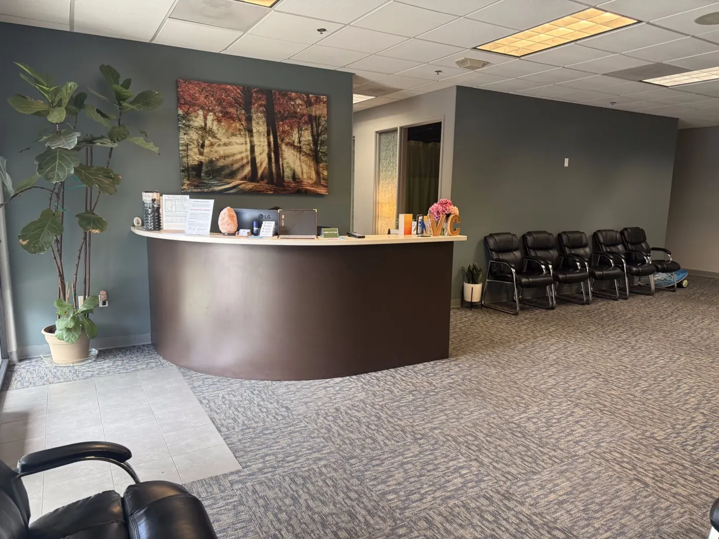 Reception desk at the Ripon chiropractic office with a curved front counter and seating for waiting patients