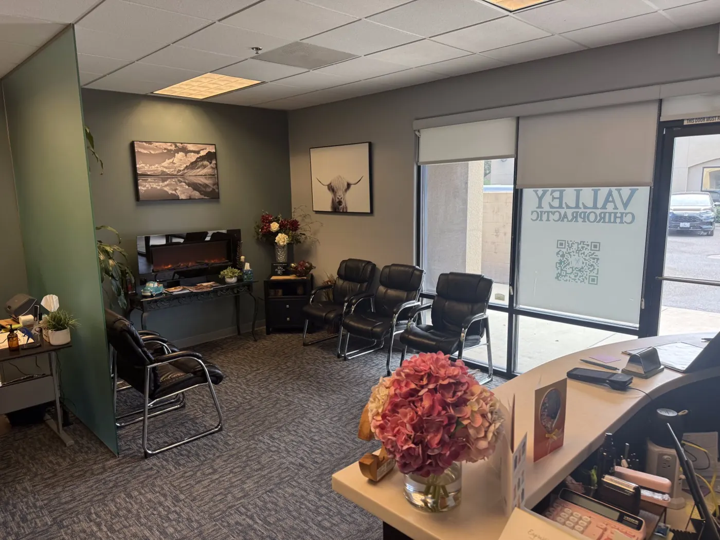 Waiting area at the Ripon office with leather chairs, a fireplace, and natural light from the front windows