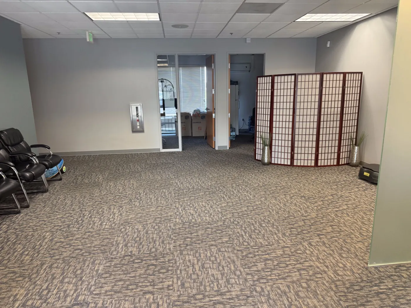 Open treatment and rehab area at the Ripon office with a folding screen and room for exercise work