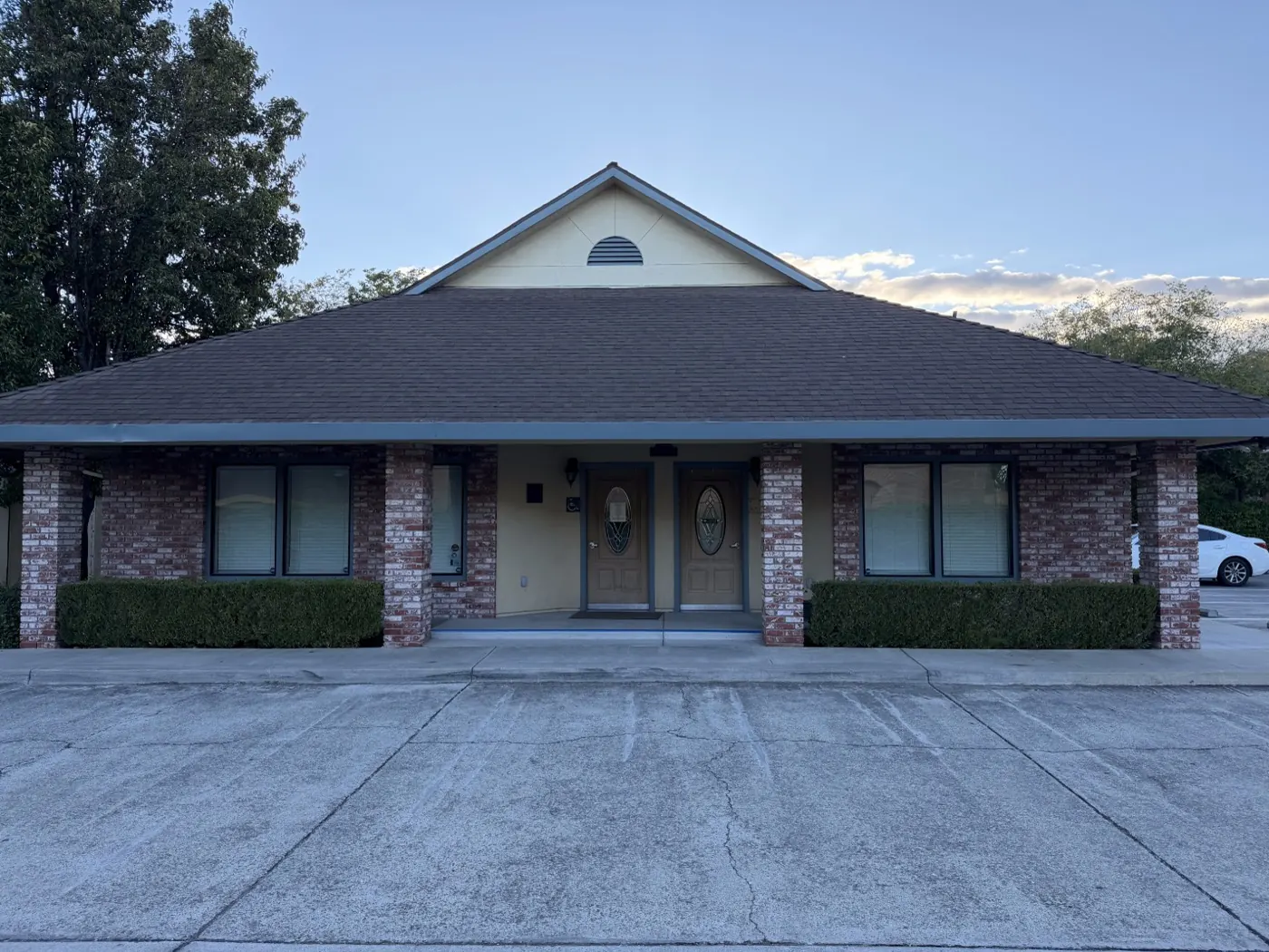 Exterior of the Valley Chiropractic Tracy office, a single-story brick building with covered entry and free parking out front