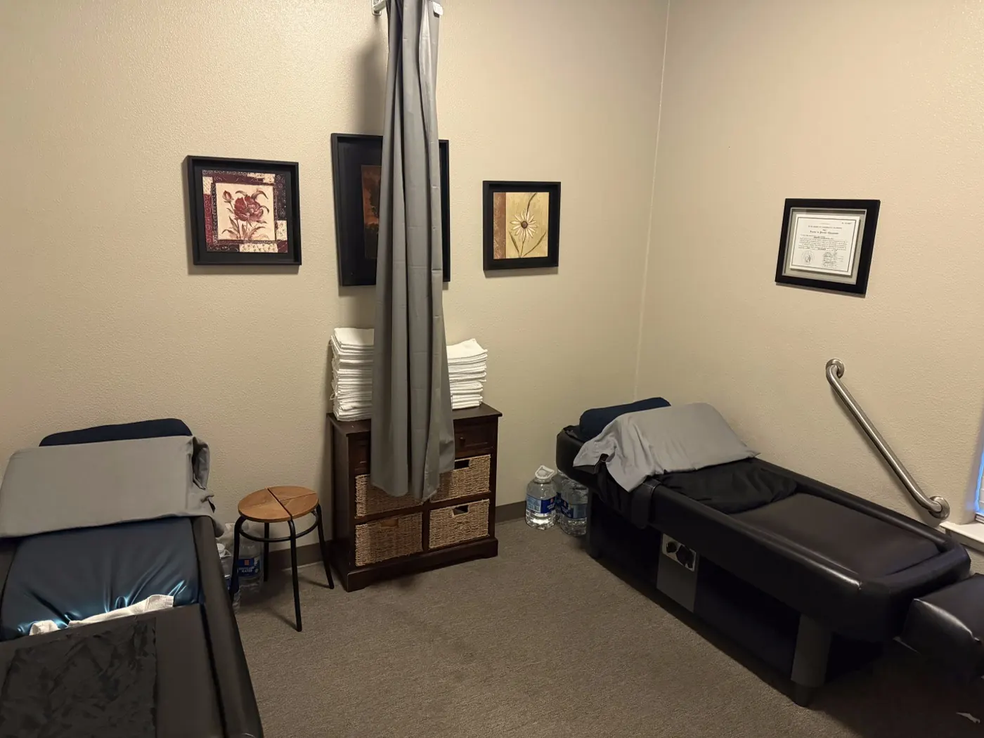 Private therapy room in Tracy with two treatment tables, fresh linens, a privacy curtain, and a support rail