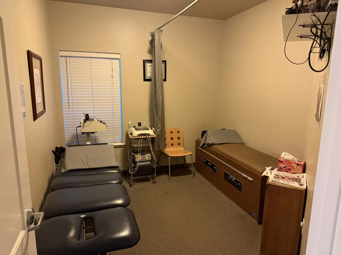 Treatment room in Tracy with a chiropractic table alongside an intersegmental traction table