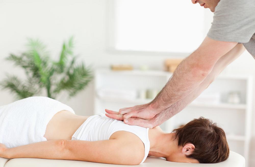 Woman receiving massage therapy from chiropractor in Tracy